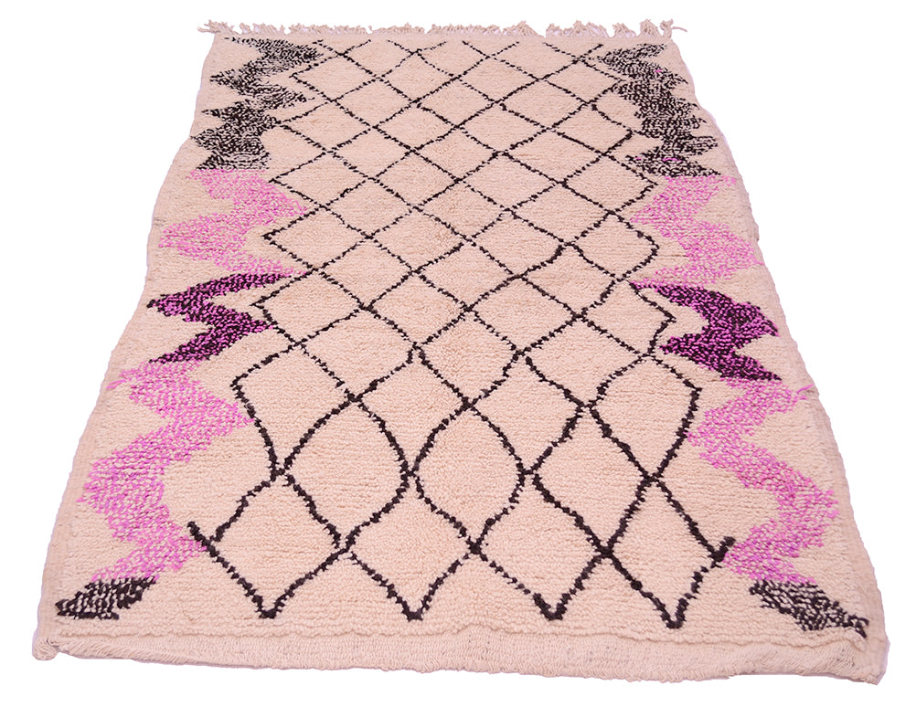 Vintage Azilal rug with symmetric black diamond pattern, magenta border accents, fringed edges.