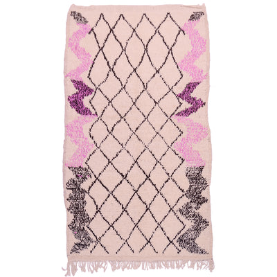 Vintage Azilal rug with light pink base, black diamond lattice, magenta accents, fringed ends.
