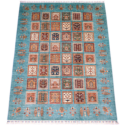 A 8x6 rectangular Afghan Bakhtiari area rug with a turquoise blue field and a grid of ornate square panels in rust, beige, navy, and cream, bordered by decorative motifs.