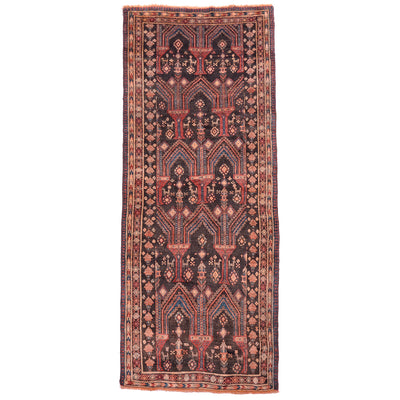 Old Belouch wide runner rug with geometric asymmetrical design on a charcoal field with detail colours of teal green, terracotta and beige.