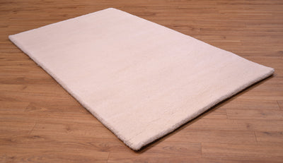 A rectangular Royal Bengal runner rug in a light cream or off-white colour, shown from an elevated angle on a brown wooden floor.