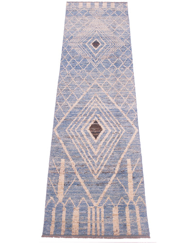 A long rectangular area runner with a blue and beige geometric diamond pattern and small brown accents, shown flat against a white background.