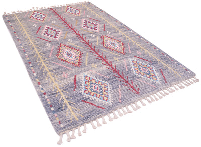 A rectangular woven Handmade Afghan Berber design rug with a light blue-grey base and a geometric tribal pattern in red, pink, yellow, and white, finished with white tassels on the ends.