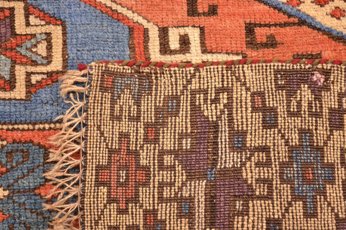 Antique Bergama rug corner close-up with textured woven detail and short fringe