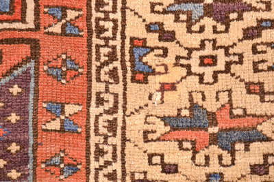 Antique geometric rug, close-up pattern with orange, beige, purple, and blue