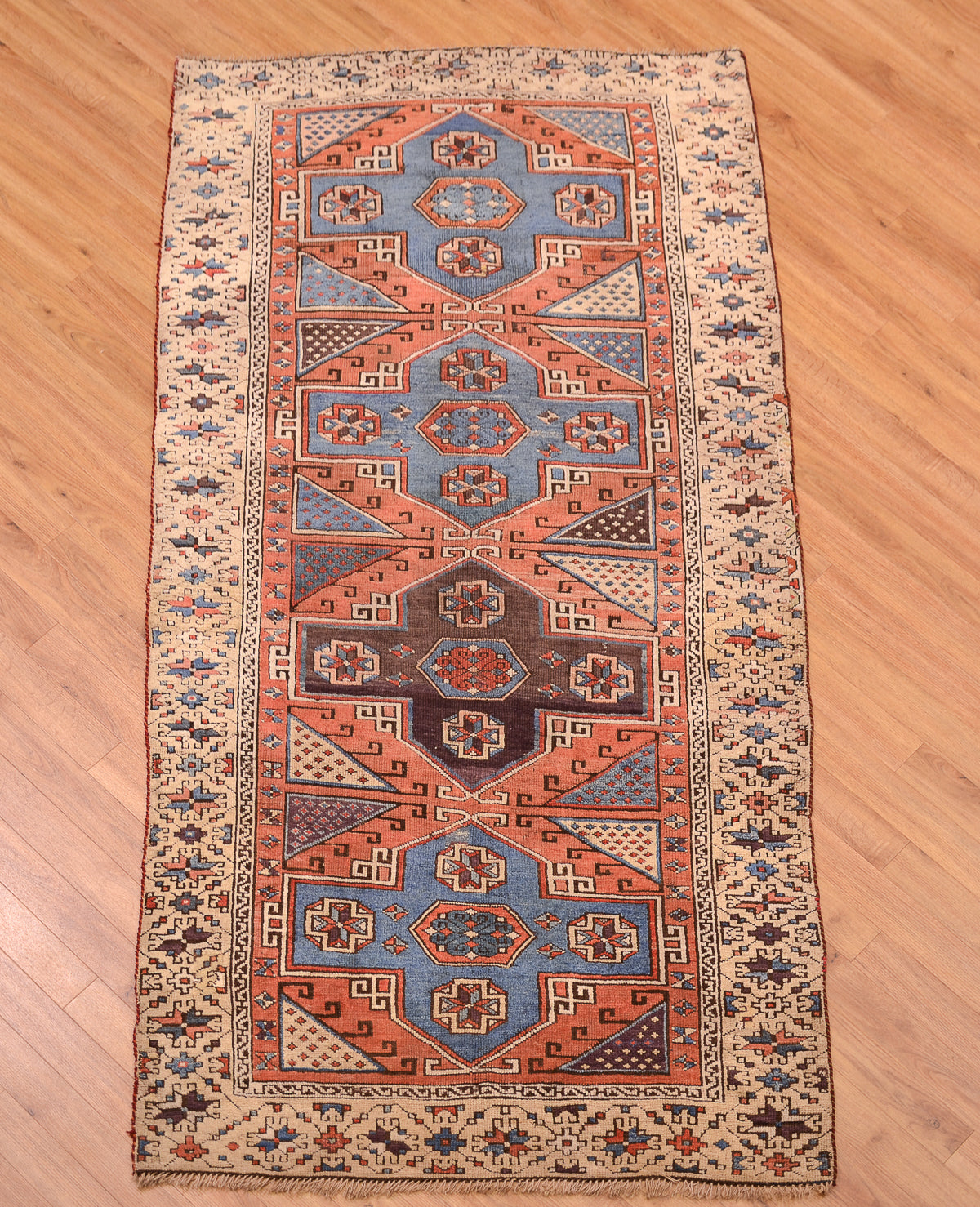 Antique Bergama rug showing full rectangular layout with orange border and blue center