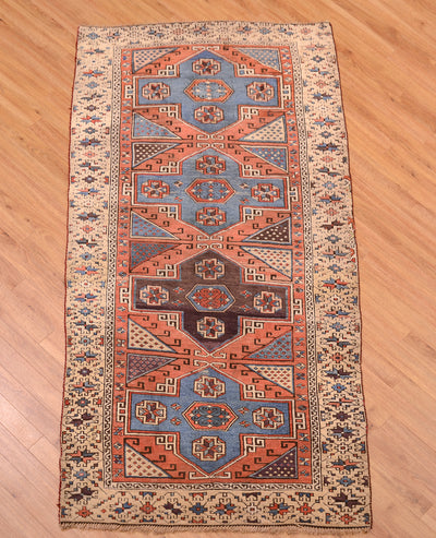 Antique Bergama rug showing full rectangular layout with orange border and blue center