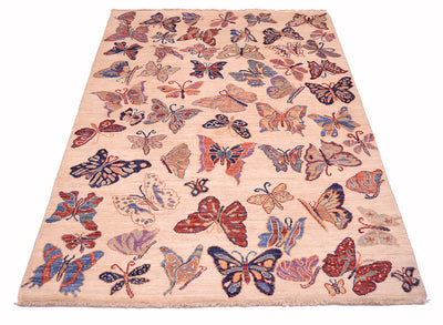 A rectangular Afghan Butterflies Rug with a cream-coloured background and an all-over pattern of hand-knotted butterflies in shades of red, blue, purple, and orange.