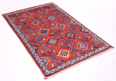 A traditional rectangular Afghan Chobi tribal design mat with a red field, blue and beige geometric motifs, and a patterned border, shown on a plain white background.