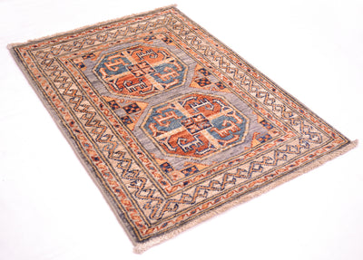 A traditional style Fil Pai Afghan Mat with a traditional geometric pattern, featuring a muted blue-grey field, rust-orange and navy blue motifs, and a patterned border, shown on a plain white background.