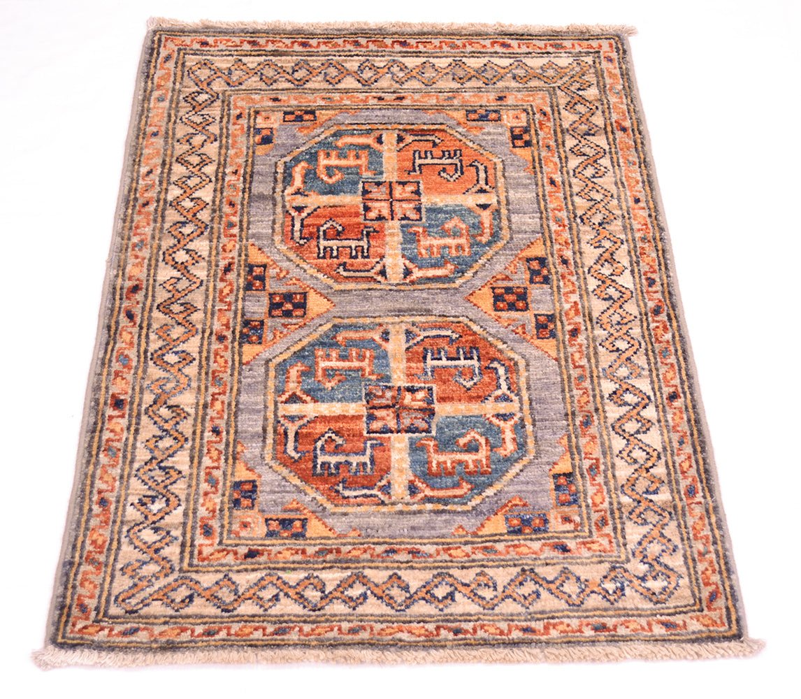 A rectangular hand-woven small Afghan Fil Pai rug or mat with a traditional geometric pattern, featuring two central medallions in rust orange, blue, and beige on a light gray field, surrounded by a detailed border.