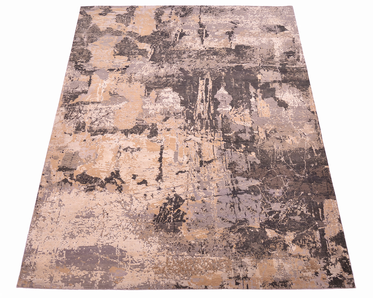 Overall view of abstract modern Indian carpet with neutral greys and clays tonalities and earthy tones. Geological like tonailites a in greys and beiges Textured wool and silk pile. 