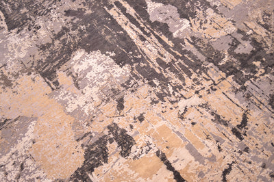 Close up view of handmade carpet with wool and silk pile with large areas of ivory cream silk highlights and textured surface with light to mid grey matte wool pile and taupe to mid brown matte wool pile.