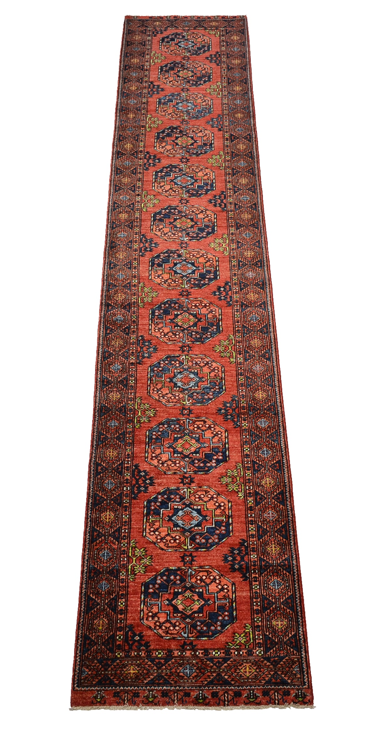 A 5m long runner rug with a traditional Afghan Ersari design, featuring a vibrant orange/rust field, dark navy blue medallions, and intricate geometric borders in beige and green.
