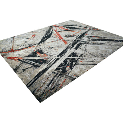Abstract handmade rug in grey, black, and red on a angled presentation