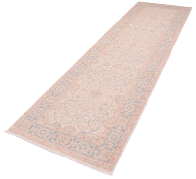 Angled view of soft coloured Feraghan design runner with pastel colours and  and light sky blue border background. 