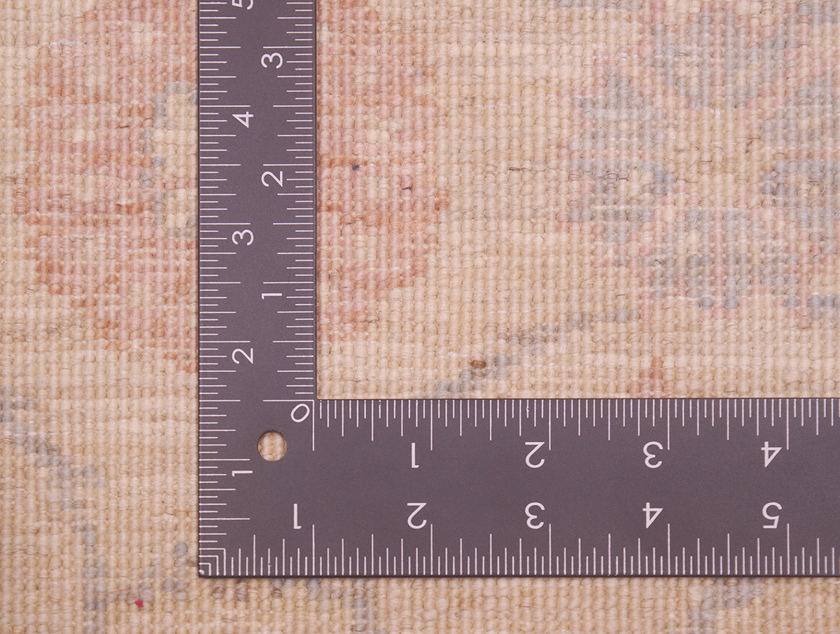 Reverse of runner rug showing handknotting and soft colour palette and fineness of weave. 