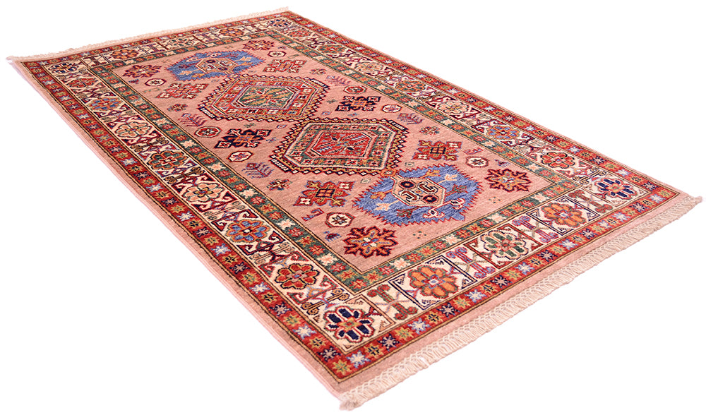 A rectangular fine handmade pink Kazak Rug with a dusty pink field, intricate multicolor geometric medallions, and a detailed border, shown on a plain white background.