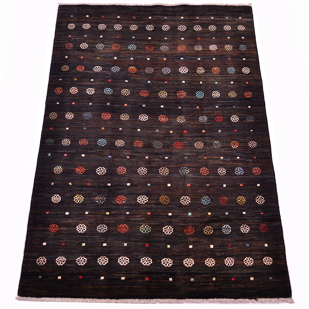 A dark brown-black rectangular 5x3 Afghan Gabbeh rug with a woven texture, decorated with rows of small geometric medallions and dots in red, blue, beige, and white, finished with a fringed edge