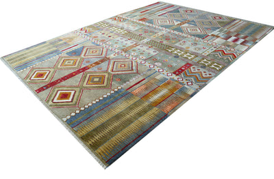 A rectangular Large handmade wool and silk Gabbeh carpet with a complex geometric design, featuring diamond and tribal-inspired motifs in muted tones of beige, grey, blue, red, and orange, shown from an elevated perspective against a white background.
