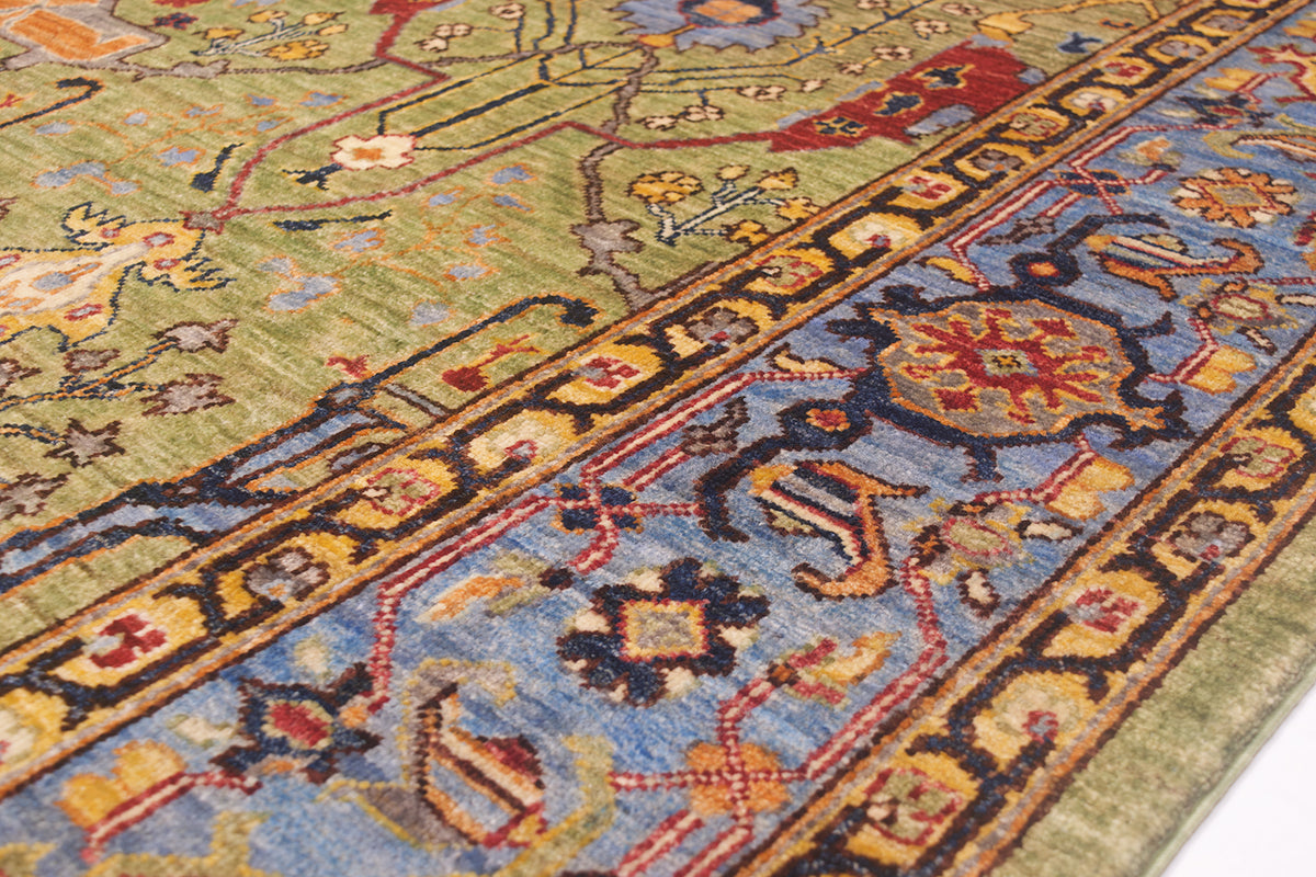 Detail of cloudband border of Garous style handmade carpet with sky blue background and dark navy blue and golden yellow detailing.