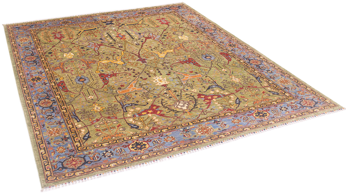 Angle view of antique style garous carpet handmade in Afghanistan wll stunning soft green field and sky blue border with traditional motifs and hints of navy blue. 