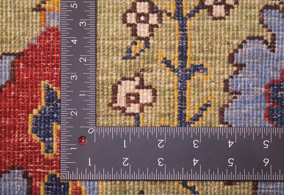 Detail showing reverse of handmade carpet with handknotting and stylized botanical designs,