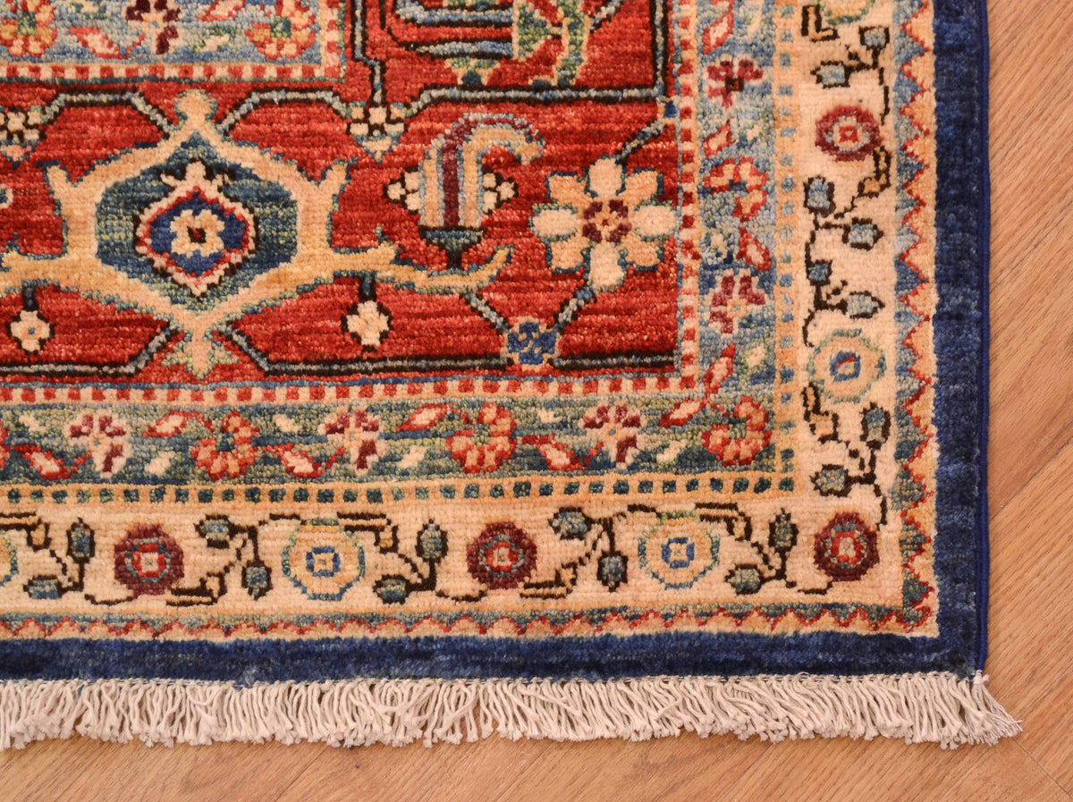 Corner detail of garous carpet with secondary colours of teal green and golden yellows. Floral meander minor borders encapsulatiing a traditional cloudband border design.