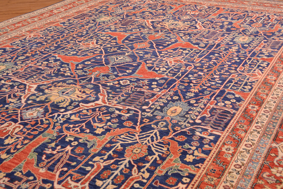 Detail of highly decorative field of Afghan Garous design carpet with rich blue ground and ornate network of vines and tendrils with yellow gold, red, and teal greens and light blues. Appendaged blossoms to tendrils and alos floating in the main field. Classic design.