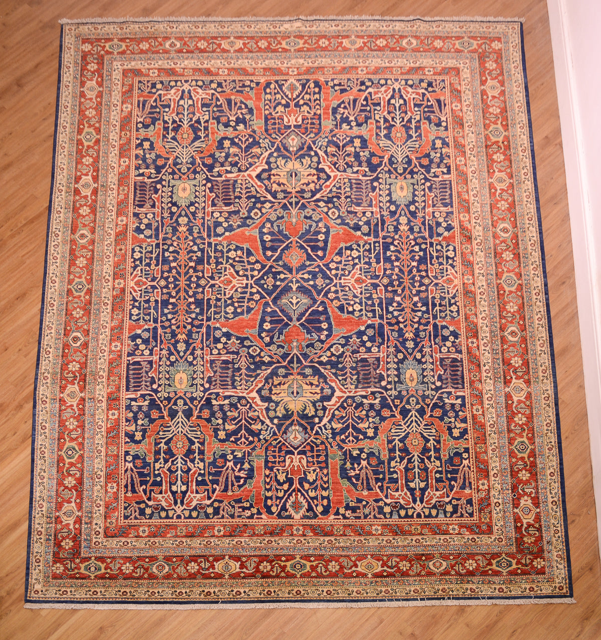  Deep blue ground all over geometric patterned handmade carpet from Afghanistan of Persian Garous design. Distinctive design with multiple network of vines and geometricised flowers. Rich colours of red, blue and gold with cloudband border with floral minor borders.
