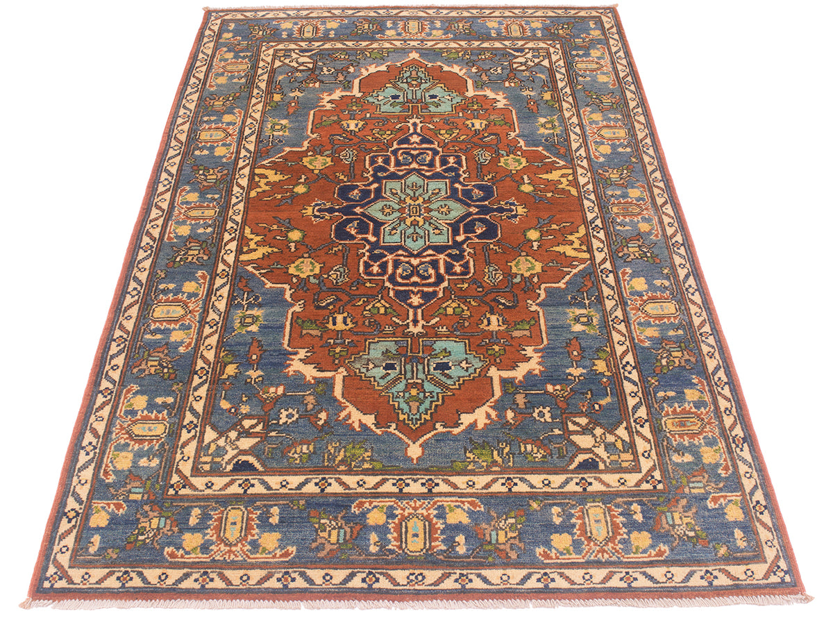 A traditional 6x4 oriental Heriz area rug with a complex geometric and floral pattern, featuring a central medallion in rust red and teal, surrounded by a blue field and beige borders.
