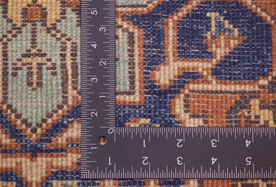 Close-up of the hand-knotted back of an Afghan Heriz 6x4 rug with a dark ruler placed over it to show scale, showing a blue, tan, and brown ornamental pattern.