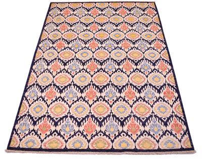 All-over ikat textile inspired handmade carpet from Afghanistan with varity of pleasing colours of cream, blues, terracotta corals, green and yellow. Flamelike ikat style all over medallion design.