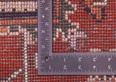 Close-up of the hand-knotted back of Indian Heriz rug with a dark gray L-square ruler placed over it to show scale, highlighting the woven texture and multicolour design.