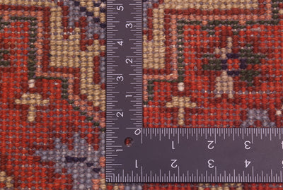 Close-up of the hand-knotted underside of Indo Heriz long runner with a dark ruler placed vertically and horizontally to show scale, featuring a red, beige, gray, and green geometric design.