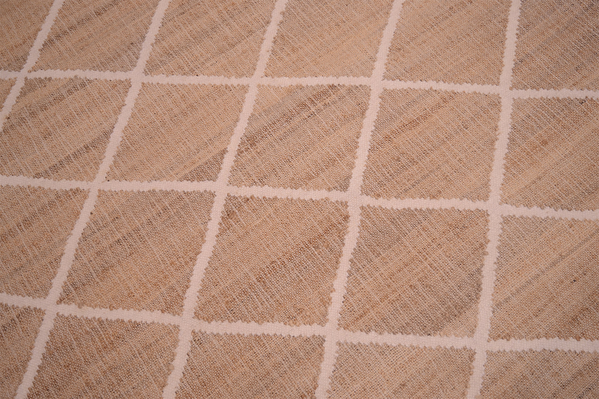 Close up of jute kilim with cream lattice design