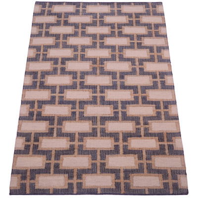 A rectangular area rug with a geometric pattern of beige rectangles on a textured navy blue background.