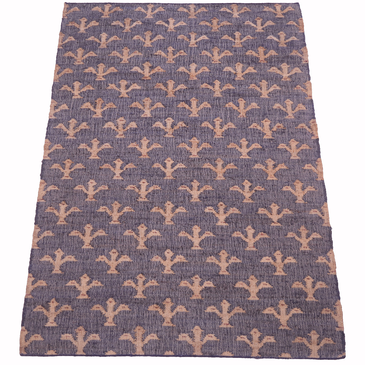 A rectangular area rug with a textured, woven surface featuring a repeating pattern of stylized fleur-de-lis motifs in a muted peach-beige color on a dusty blue-gray background.