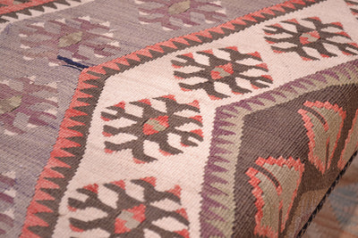 Detailed view of kilim bench with vontage kilim and natutal variations of softened tones in cream, brown, greys, mauves and chestnut. 