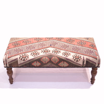 Kilim Bench Stool upholstered with a vintage Turkish Kilim in colours of cream, grey-mauve, soft light green and terracotta/ soft rusts. With a white background. Solid wooden legs.