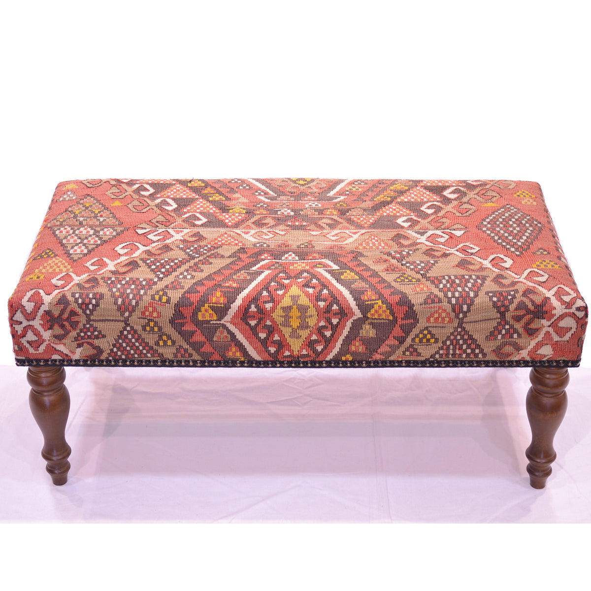 Vintage Kilim Bench Stool with geometric design in terracotta, cream, golden ochre and dark chestnut brown. Solid dark wood turned legs. Kilim motifs and hooked medallions.