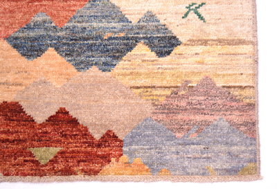 Corner of handmade carpet with kaleidoscopic colourationa and multicoloured in vibrant earthy colours. Woven on cotton warps. White cotton fringes.