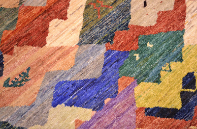 Close up detail of main field of colourful abstract carpet with interlocking forms and multiple colours juxtapostioning of complimenting colours.