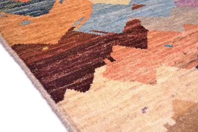 Close up detail of edge selvedge of carpet with earthy tones and handspun wool dyed with natural artisan vegetable dyes. Chesnut, cream, terracotta , amber and blue /grey colours.