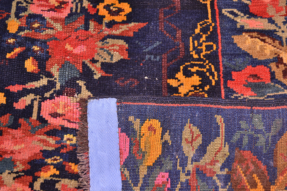 Reverse of antique floral gul farang  rug with fine knotting and wool warp thread frignes. Blue, pink, teal, ligth green and golden ochre floral filled field. 