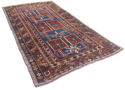 A traditional Caucasian Antique Karagashli rug with a geometric pattern, featuring a navy blue field, rust red squares, and beige borders, shown on a plain white background.