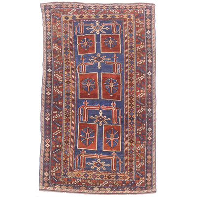 Blue ground with rust, cream & gold antique karagashli rug with geometric design.