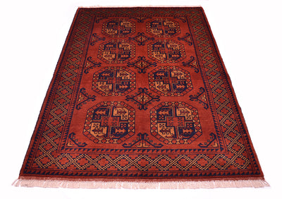 A traditional oriental Afghan rug with a deep rusty-red field, featuring geometric fil pai guls and a patterned border in dark blue-black, and soft orange, finished with cream fringe.