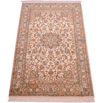 A traditional silk area rug with an intricate floral and medallion pattern, featuring a cream base with dusty pink, blue, and green accents