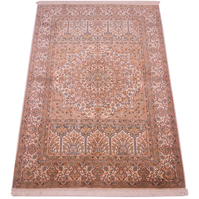 A traditional Kashmir rug with an intricate floral and geometric pattern in shades of beige, dusty pink, and muted blue, featuring a central medallion
